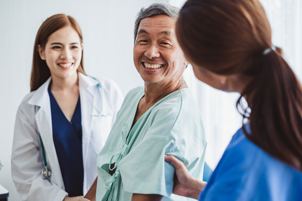 A happy patient consults with his doctors.